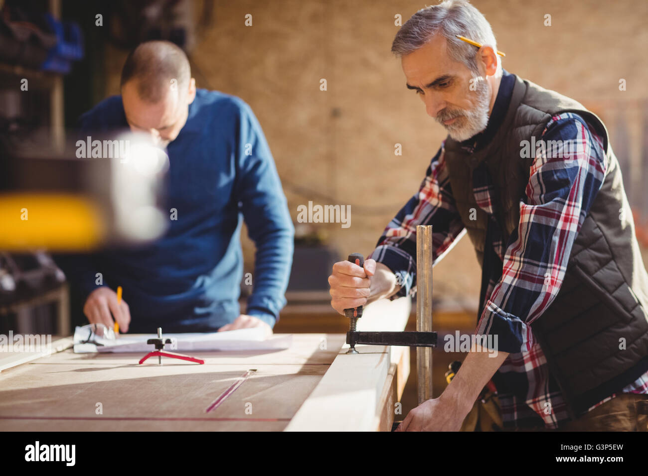 Carpenter fixing a plank of wood Stock Photo