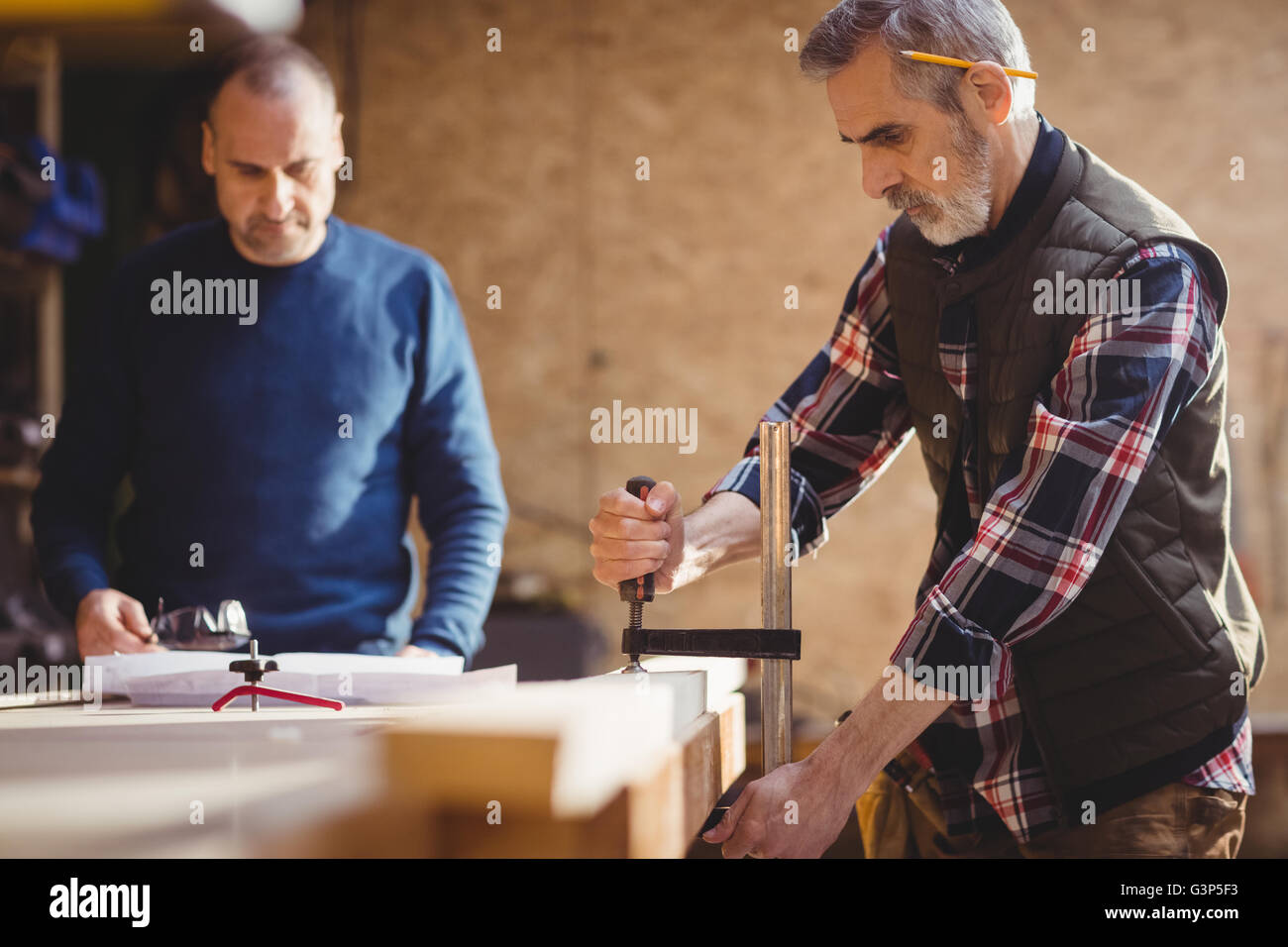 Carpenter fixing a plank of wood Stock Photo Alamy