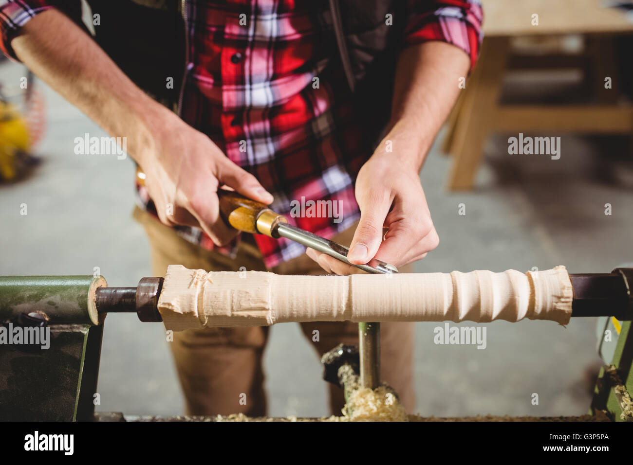 Carpenter sculpting a wood piece Stock Photo