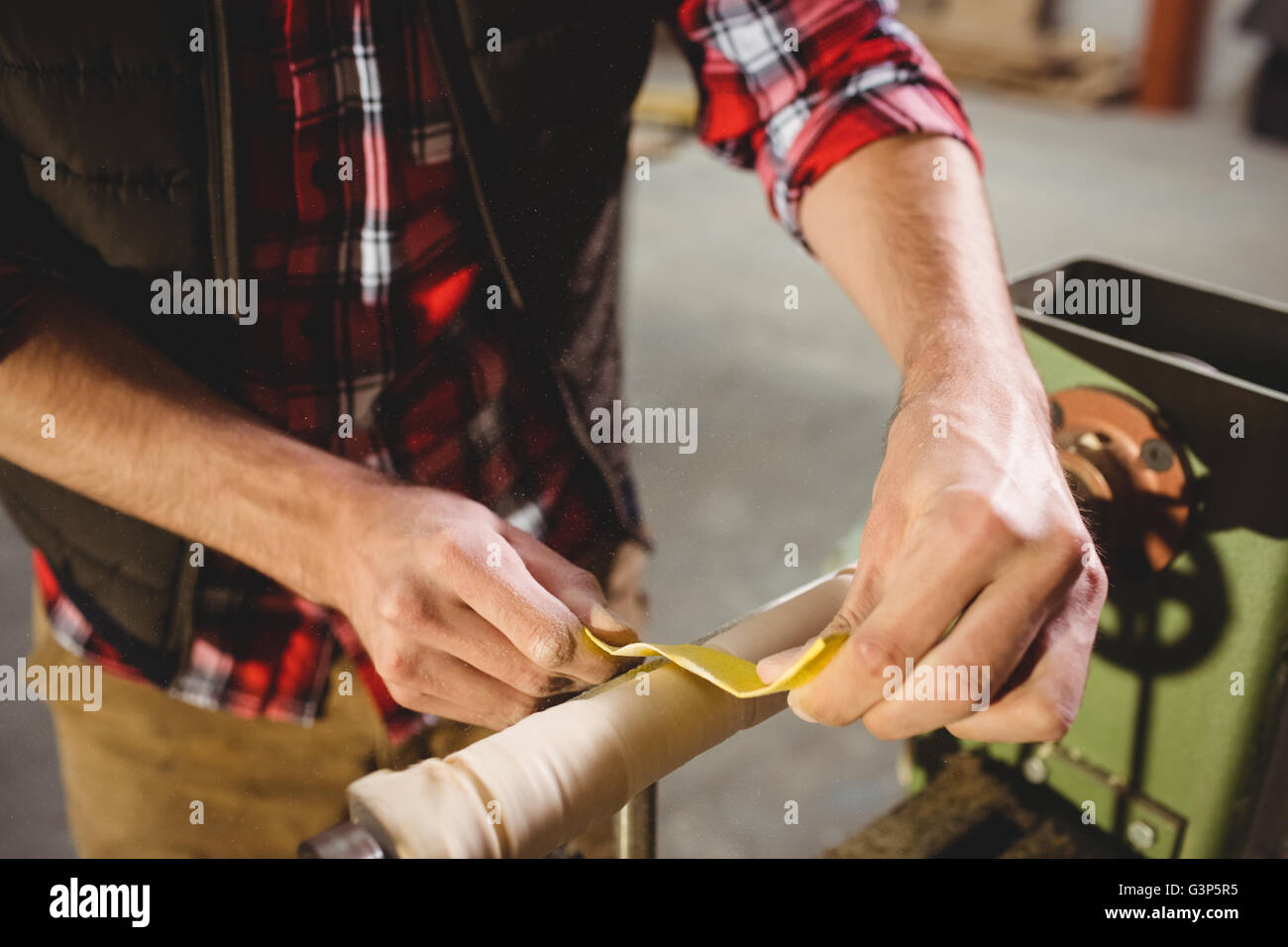 Carpenter sculpting a wood piece Stock Photo