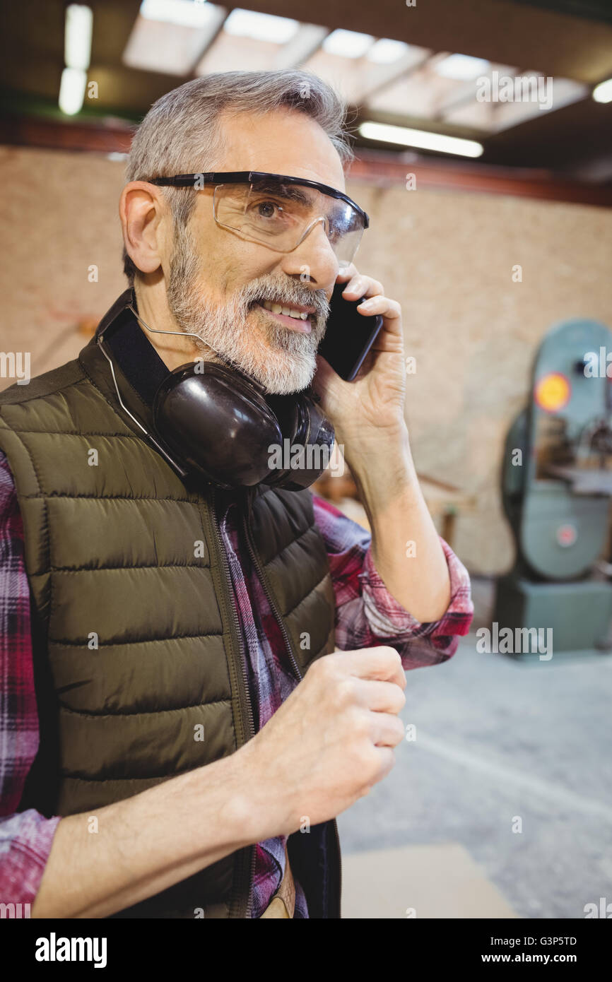 Portrait of a carpenter on the phone Stock Photo