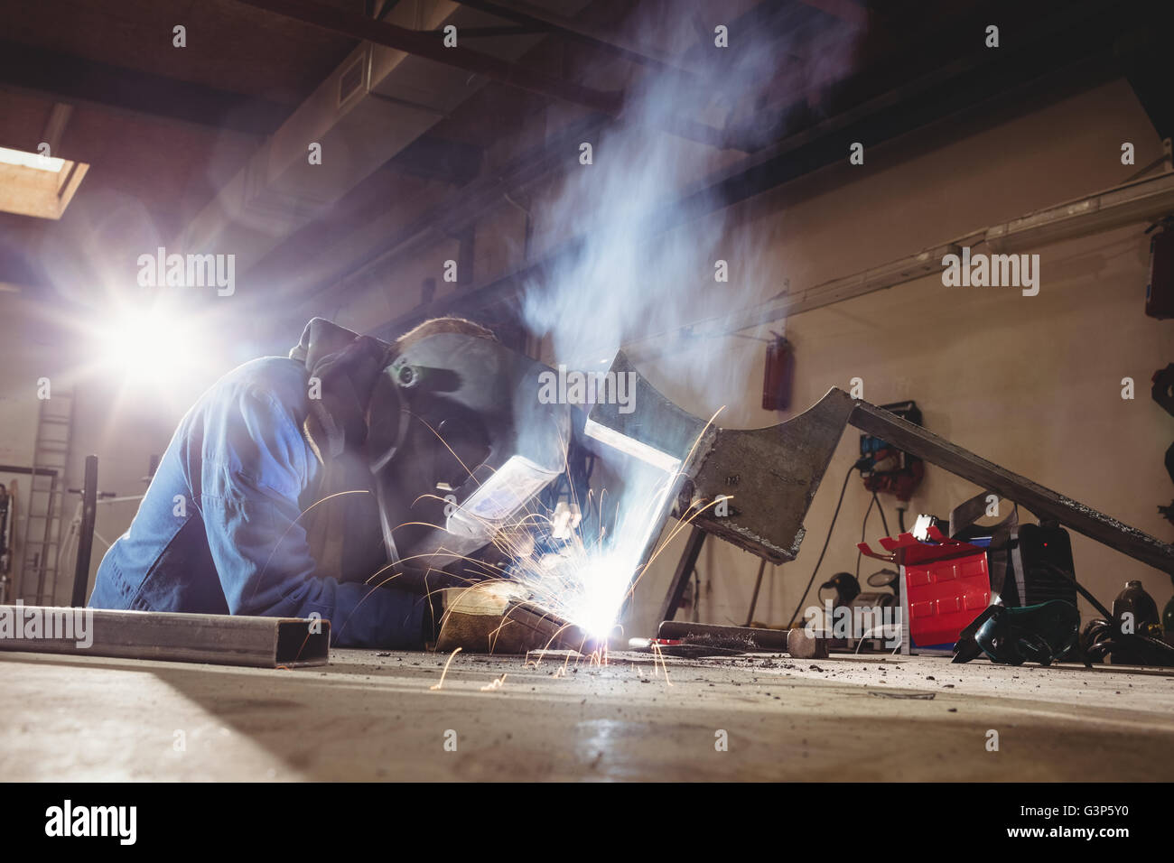 Welder cutting metal with grinder Stock Photo