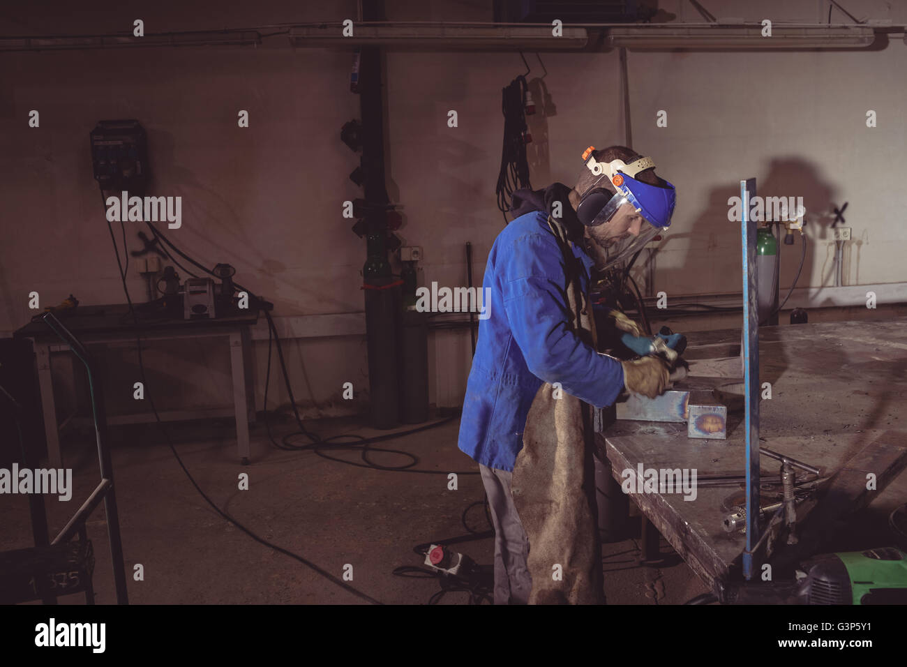 Welder cutting metal with grinder Stock Photo Alamy