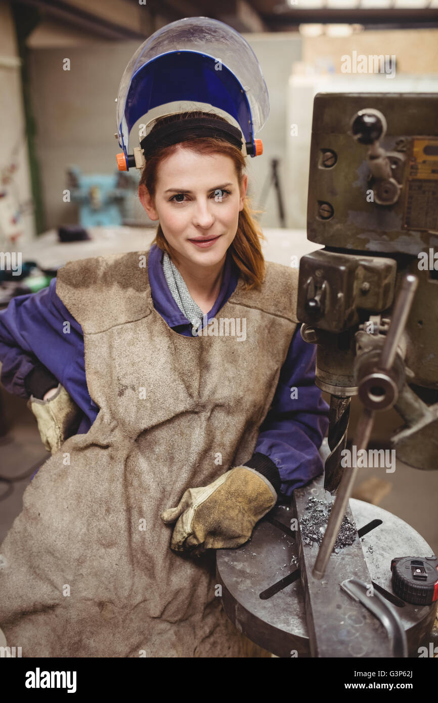 Portrait of woman welder posing beside a machine Stock Photo Alamy
