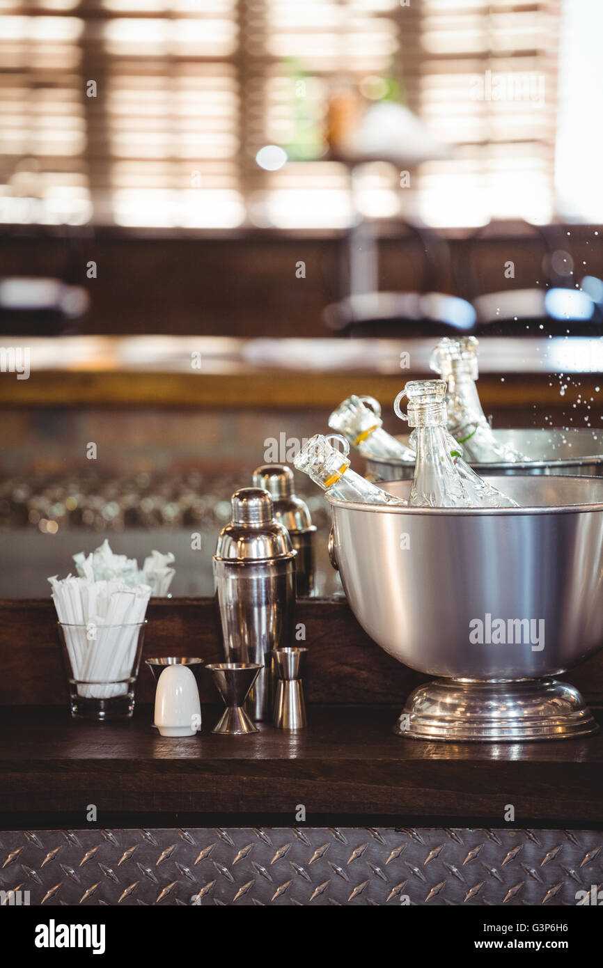 Bottles of cocktail in ice buckets on bar counter Stock Photo