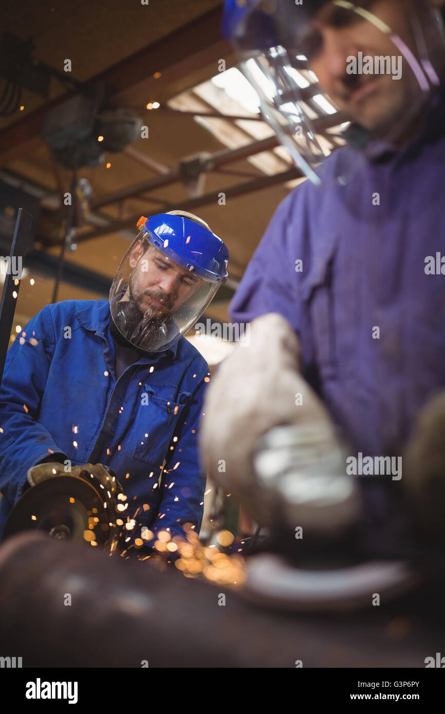 Men cutting metal with circular saw Stock Photo Alamy