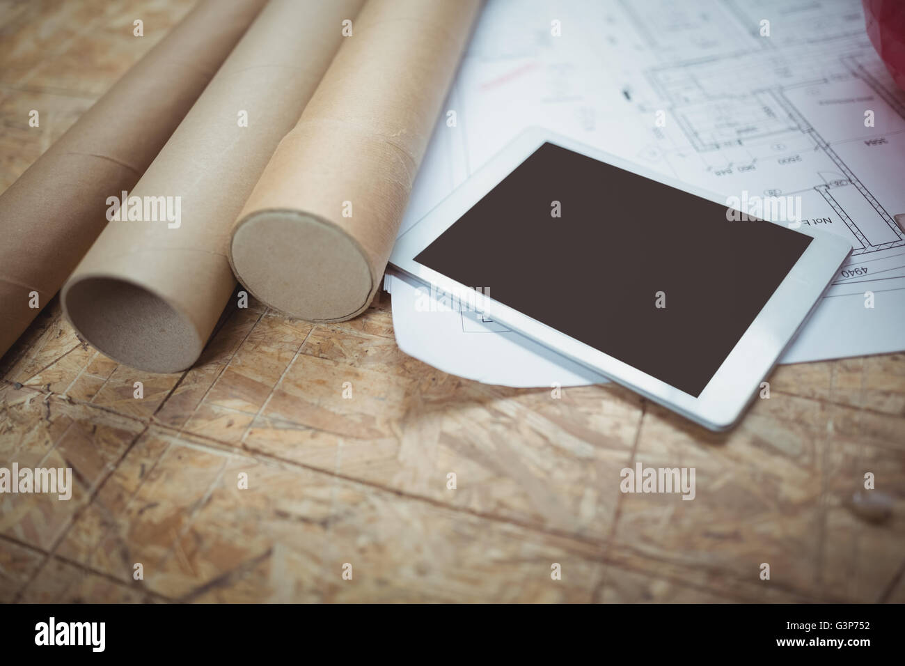 Digital tablet and blueprint on a table Stock Photo