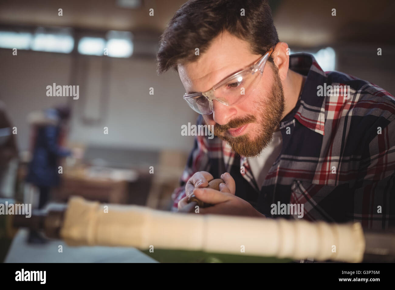 Carpenter working on a machine Stock Photo