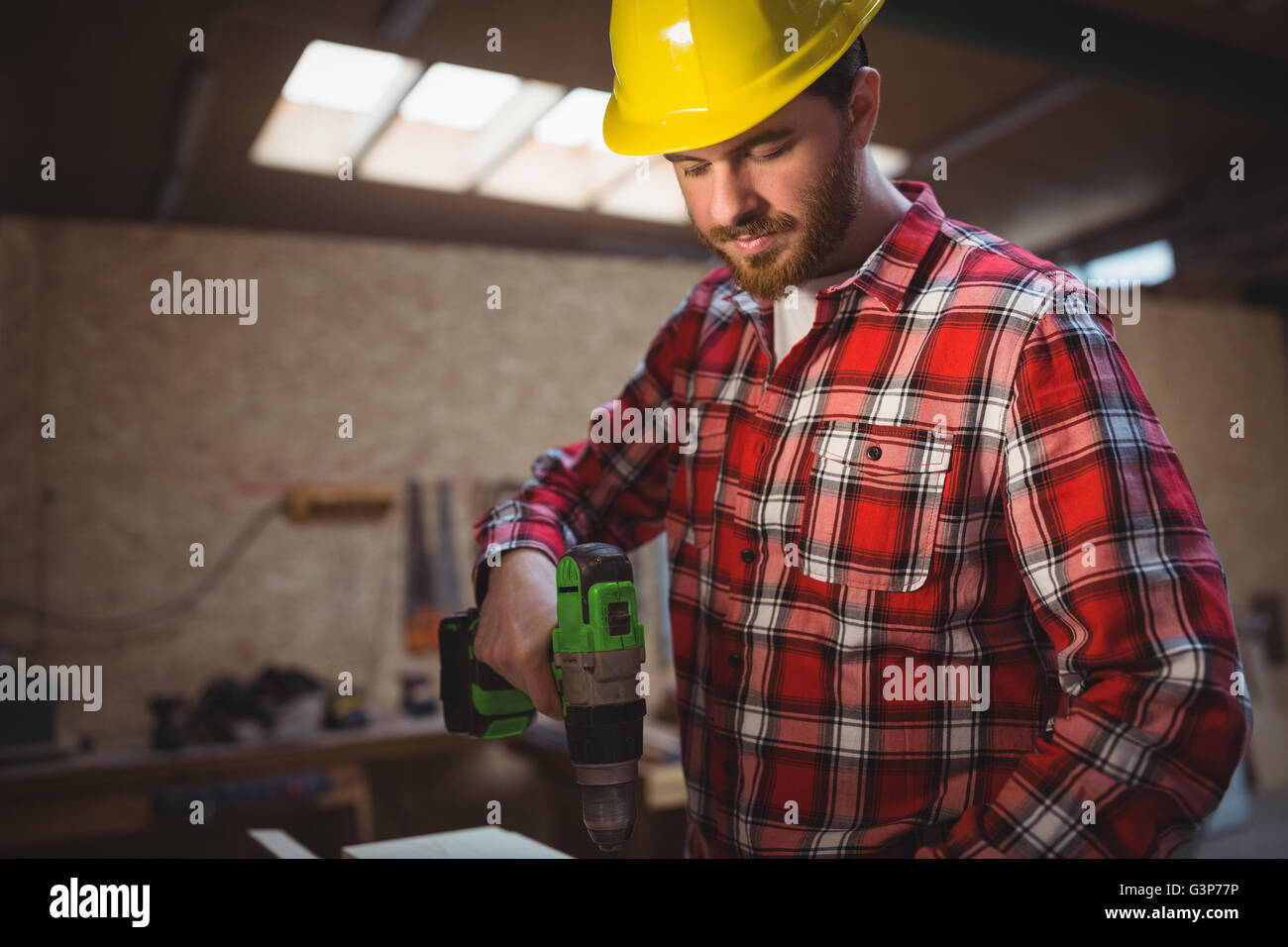 Carpenter using drill machine Stock Photo