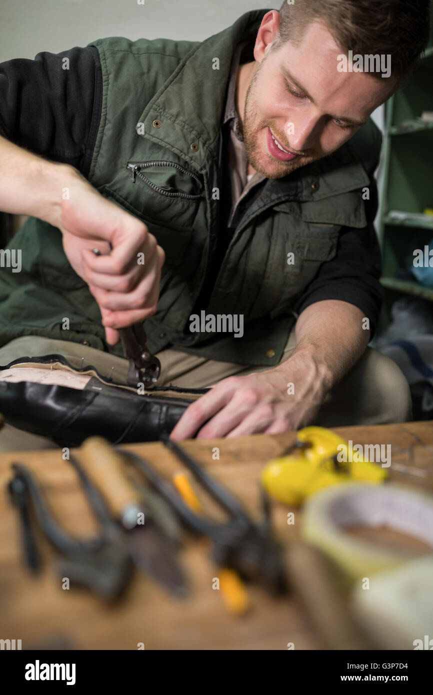 Cobbler repair shoes sole in Stock Photo Alamy