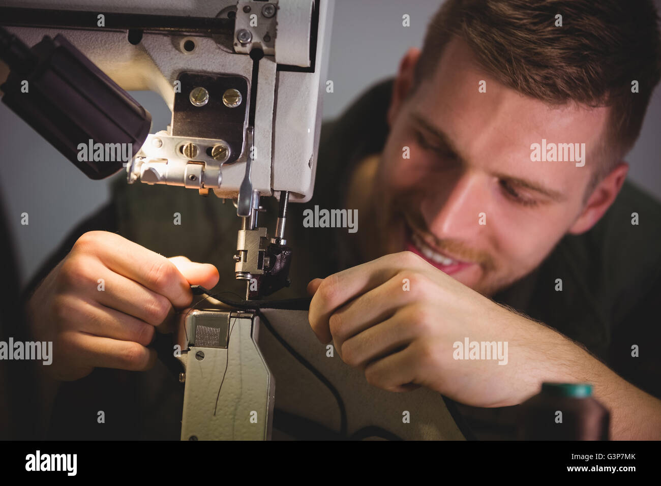 Cobbler using sewing machine Stock Photo Alamy