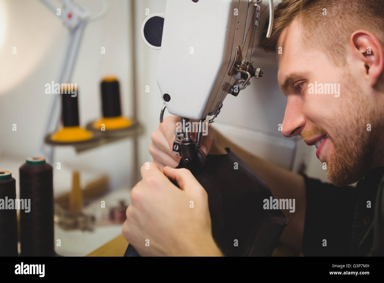 Cobbler using sewing machine Stock Photo Alamy