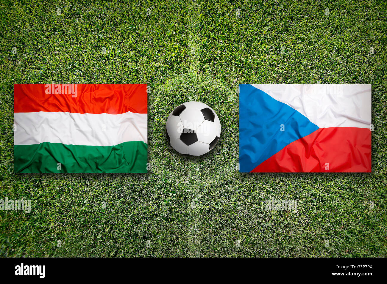 Hungary vs. Czech Republic flags on green soccer field Stock Photo