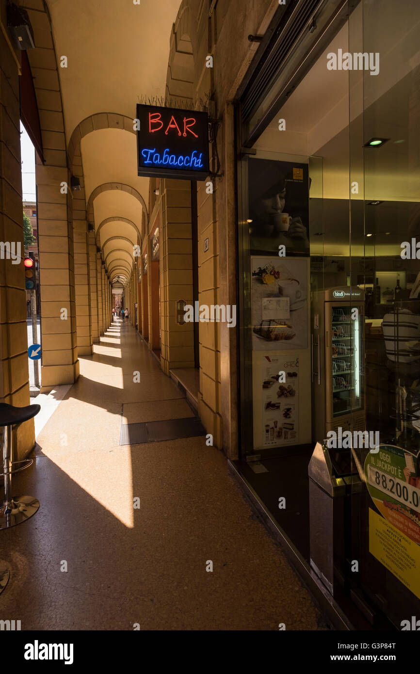 Portico and bar, tabacchi neon sign in the Via Farini, Bologna, Italy Stock Photo