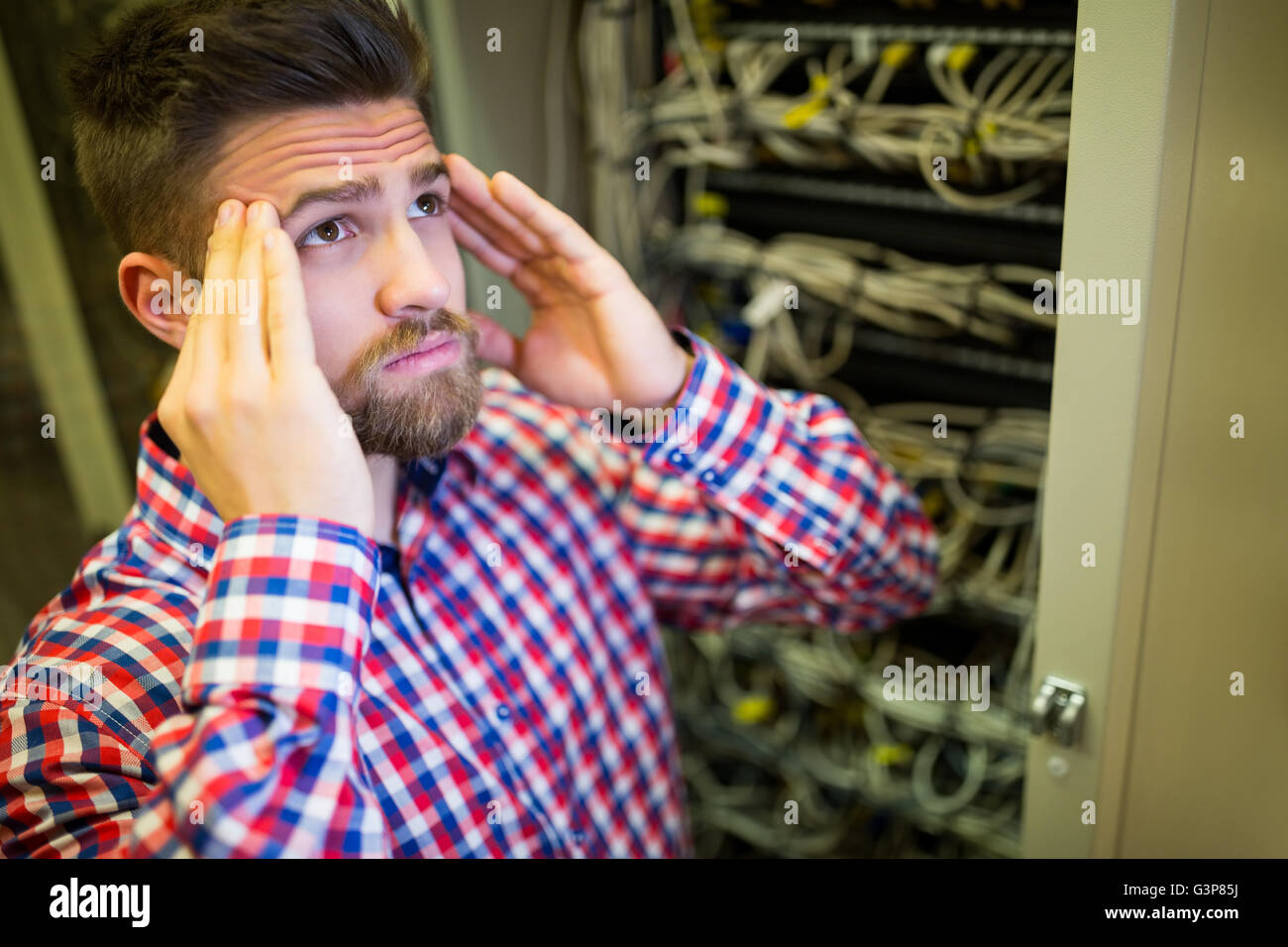 Technician getting stressed over server maintenance Stock Photo