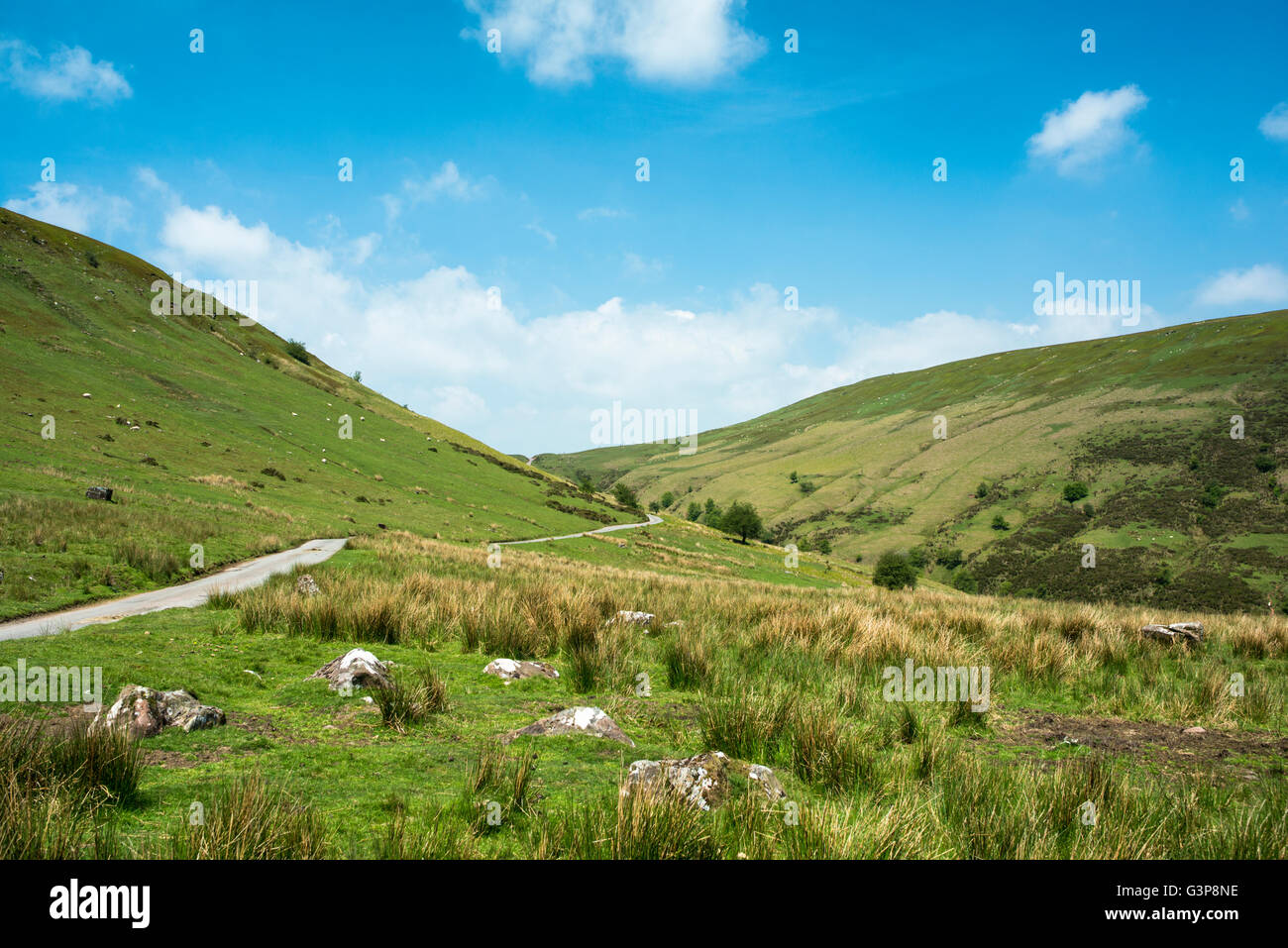 A road running through a valley betwenn two mountains. Stock Photo