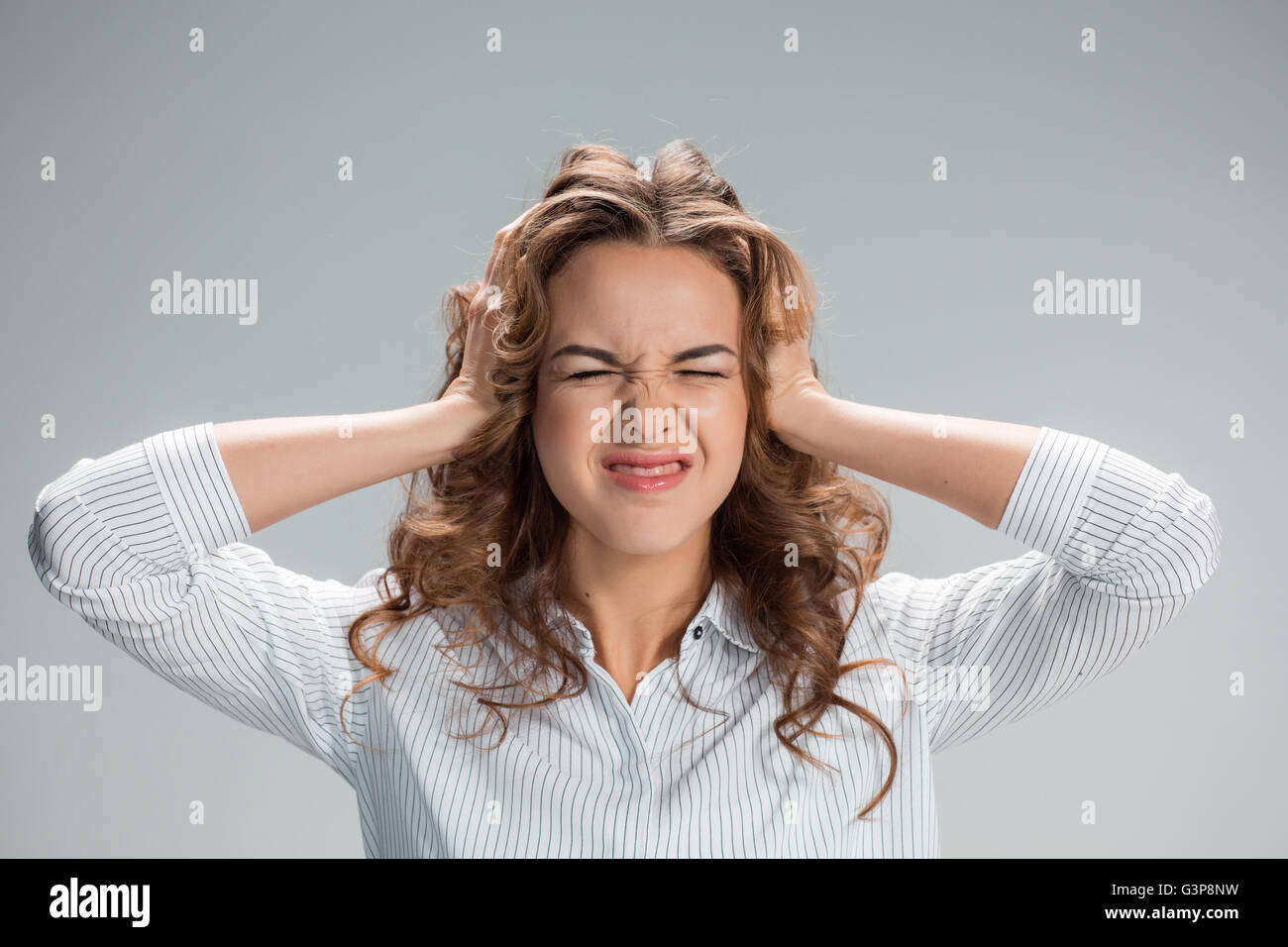 The young woman's portrait with pain emotions Stock Photo