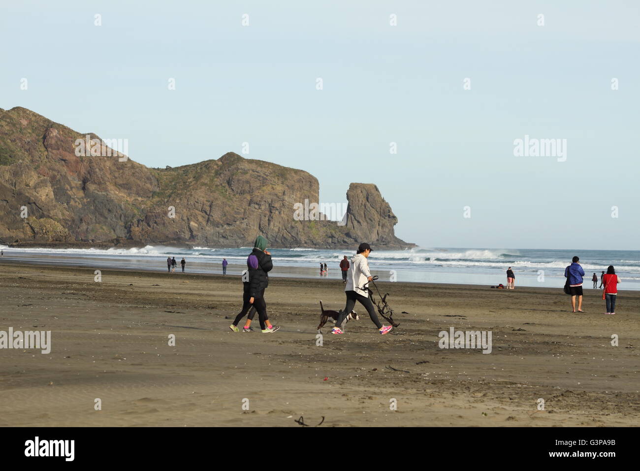 Some people on the beach in cold Winter day Stock Photo