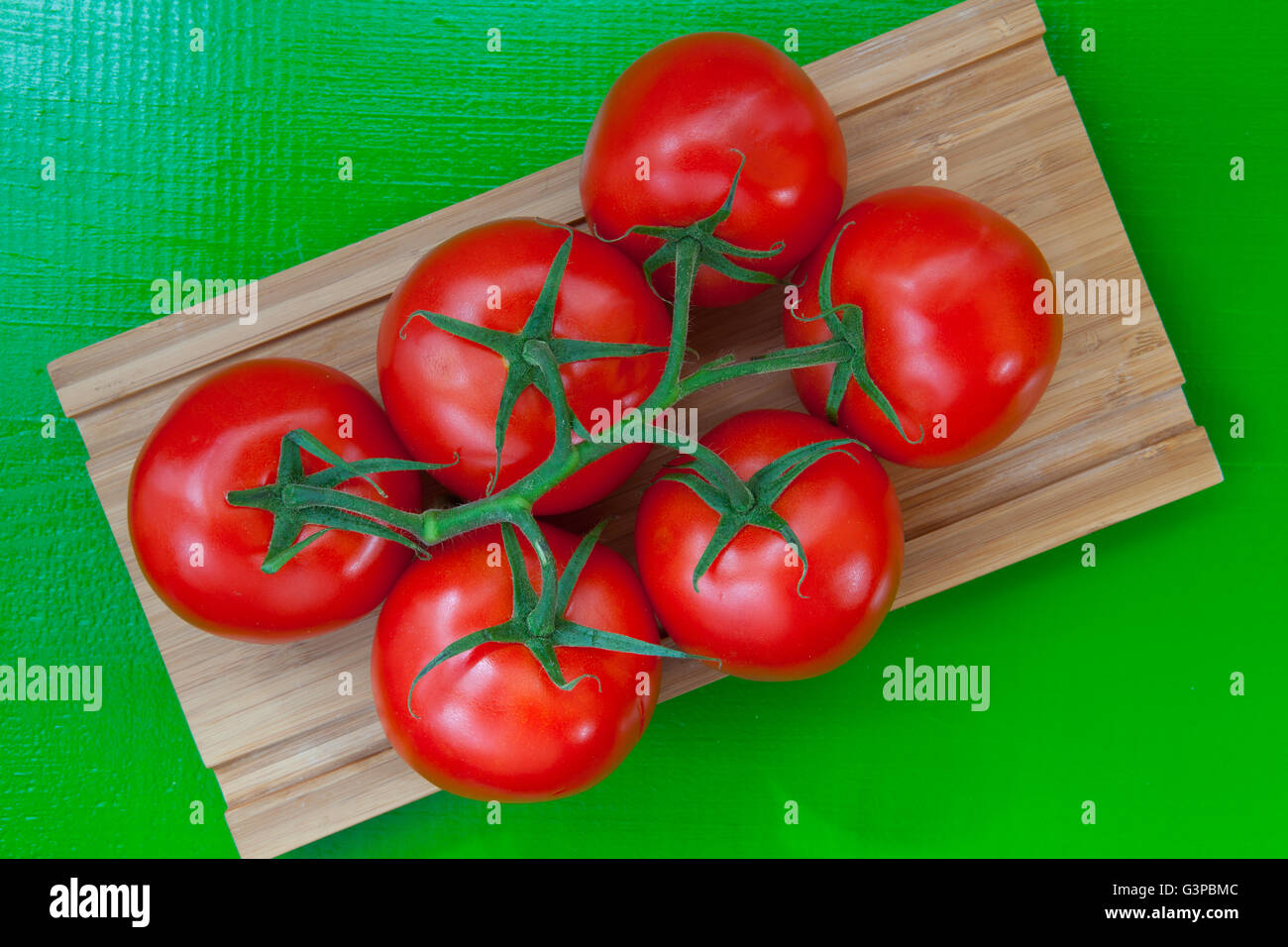 Red tomatoes on the wooden desk Stock Photo