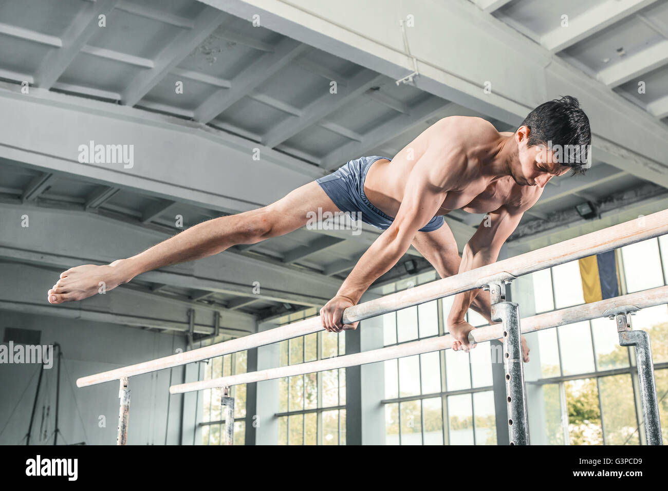 Male gymnast performing handstand on parallel bars Stock Photo Alamy