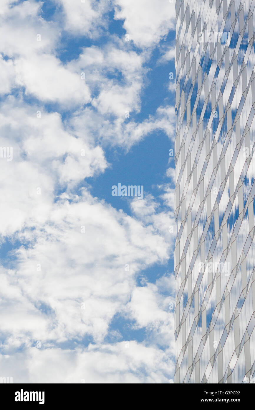 Blue sky and clouds with reflection in a glass skyscraper building with ...