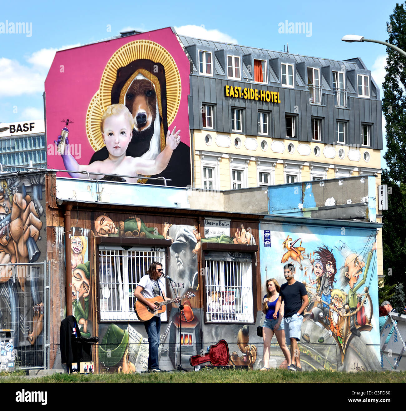 Artist Music East Side Hotel The East Side Gallery's murals graffiti street art on the 1.3km section of the German Berlin Wall by the river Spree and  Muhlenstrasse ) Friedrichshain Spree wall former border Kreuzberg Germany Stock Photo