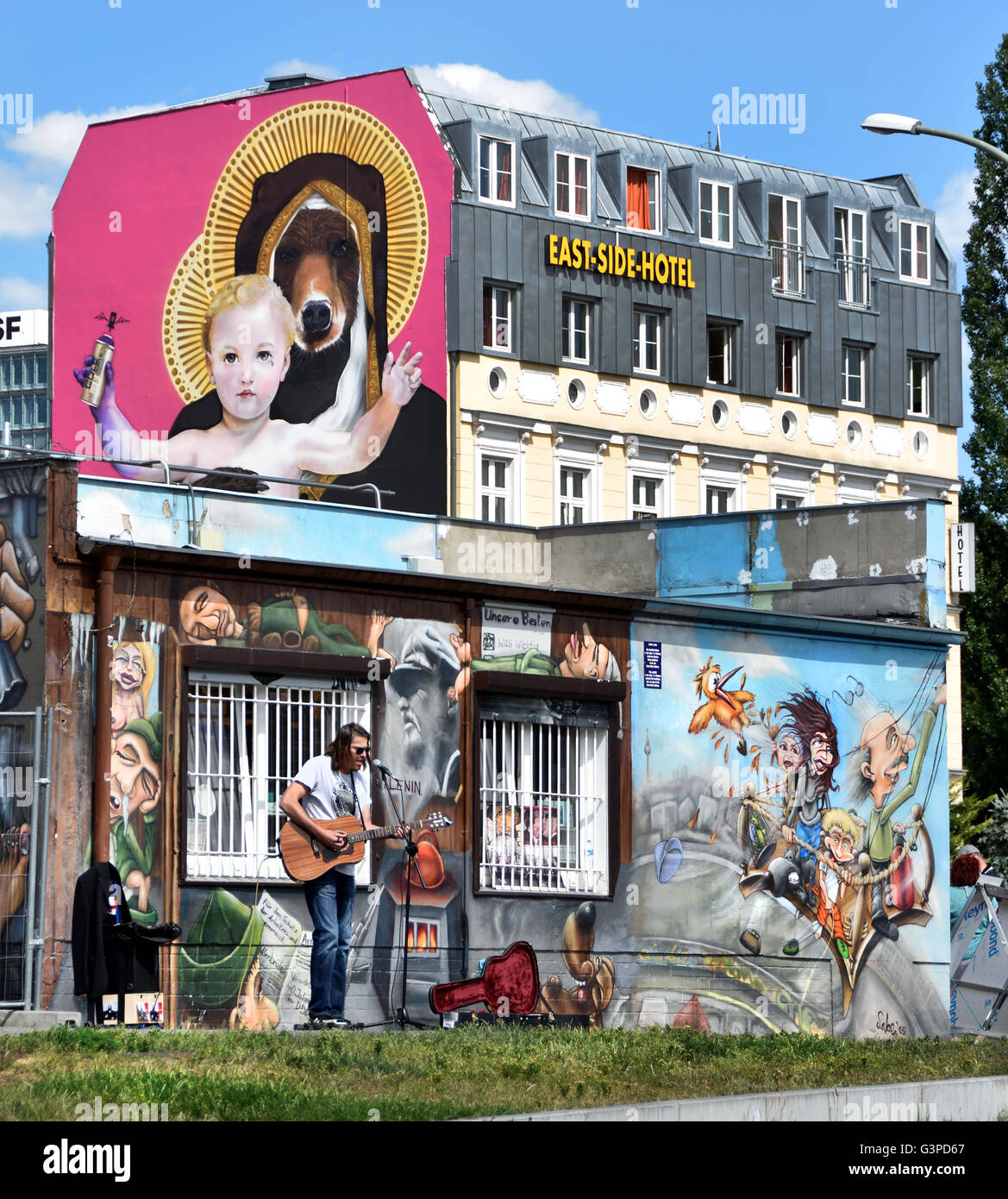 Artist Music  East Side Hotel The East Side Gallery's murals graffiti street art on the 1.3km section of the German Berlin Wall by the river Spree and  Muhlenstrasse ) Friedrichshain Spree wall former border Kreuzberg Germany Stock Photo