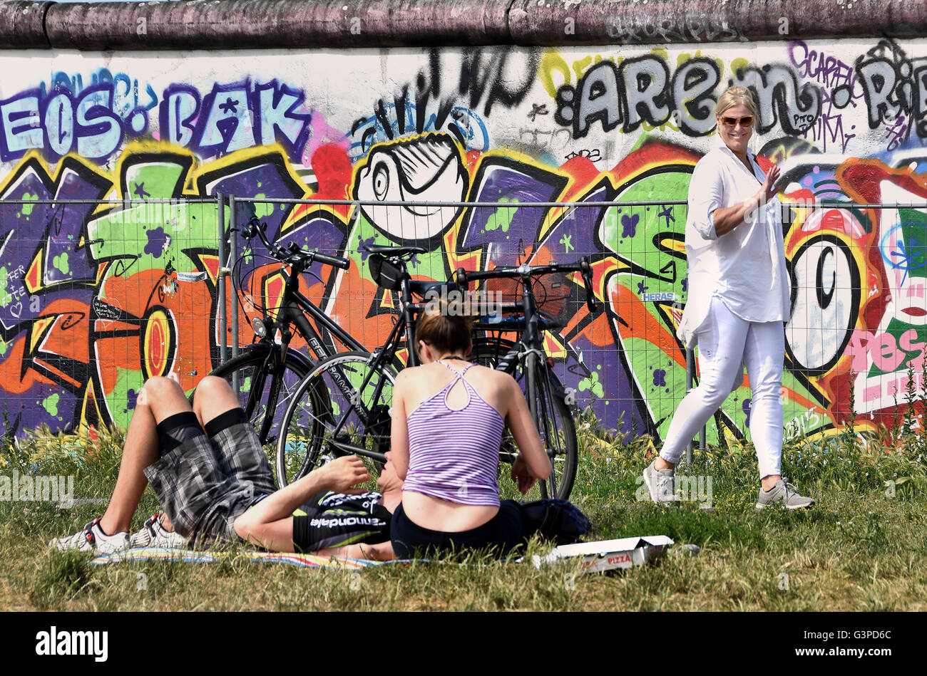 The East Side Gallery's murals graffiti street art on the 1.3km section of the German Berlin Wall by the Spree wall former border Kreuzberg Germany ( 1.3km section of the Berlin Wall by the river Spree and  Muhlenstrasse ) FriedrichshainMuhlenstrasse ) Friedrichshain Stock Photo