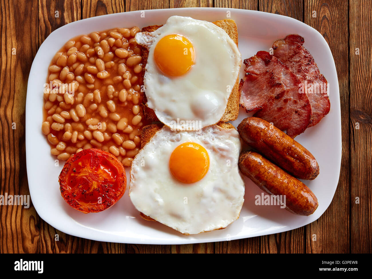 Full english breakfast fry up bacon egg sausage tomato hires stock