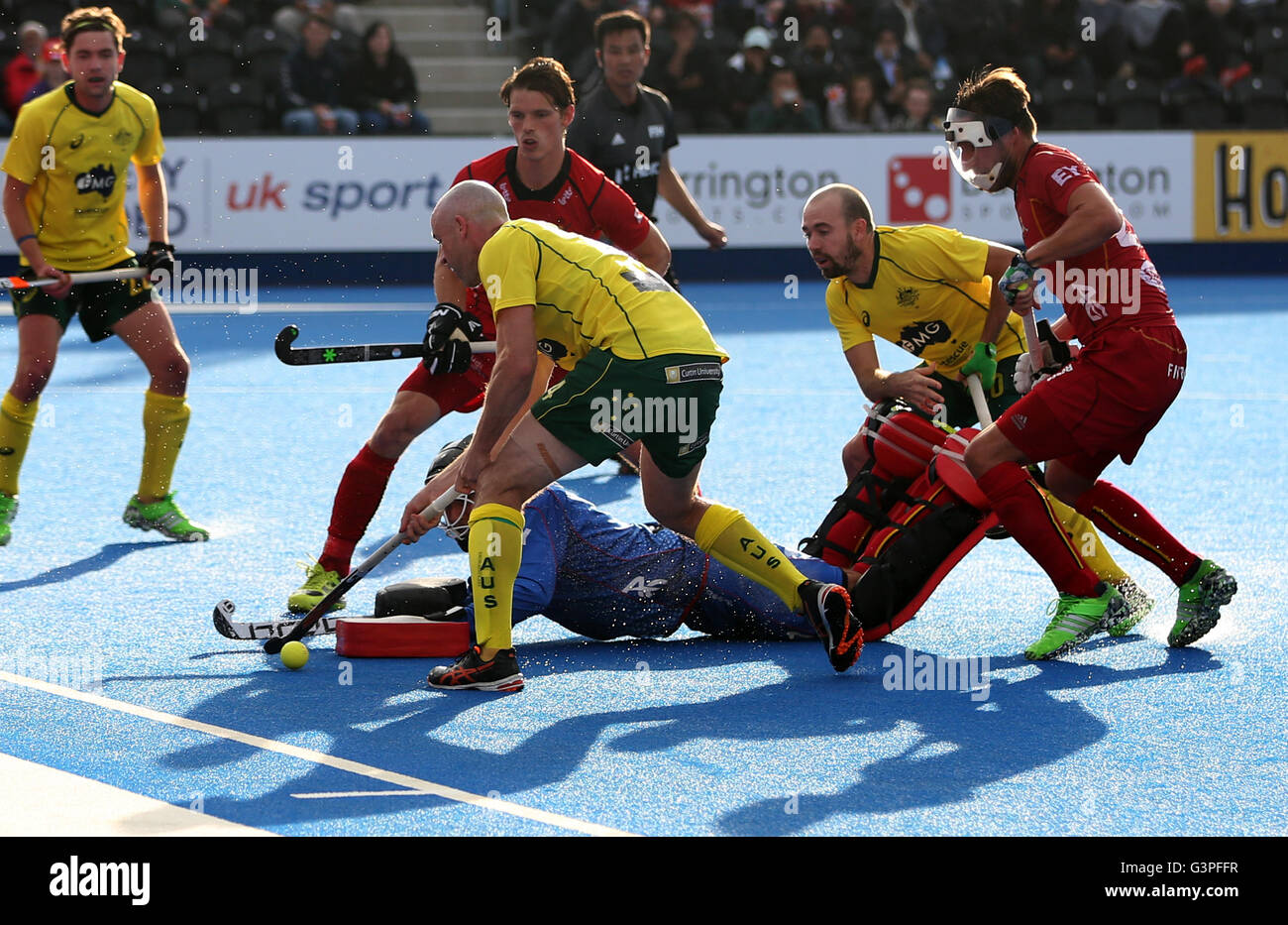 Belgium goalkeeper Vincent Vanasch dives to make a save form Australia's Glenn Turner and Australia's Tristan White battle for the ball during day four of the FIH Men's Champions Trophy at the Queen Elizabeth Olympic Park, London. Stock Photo