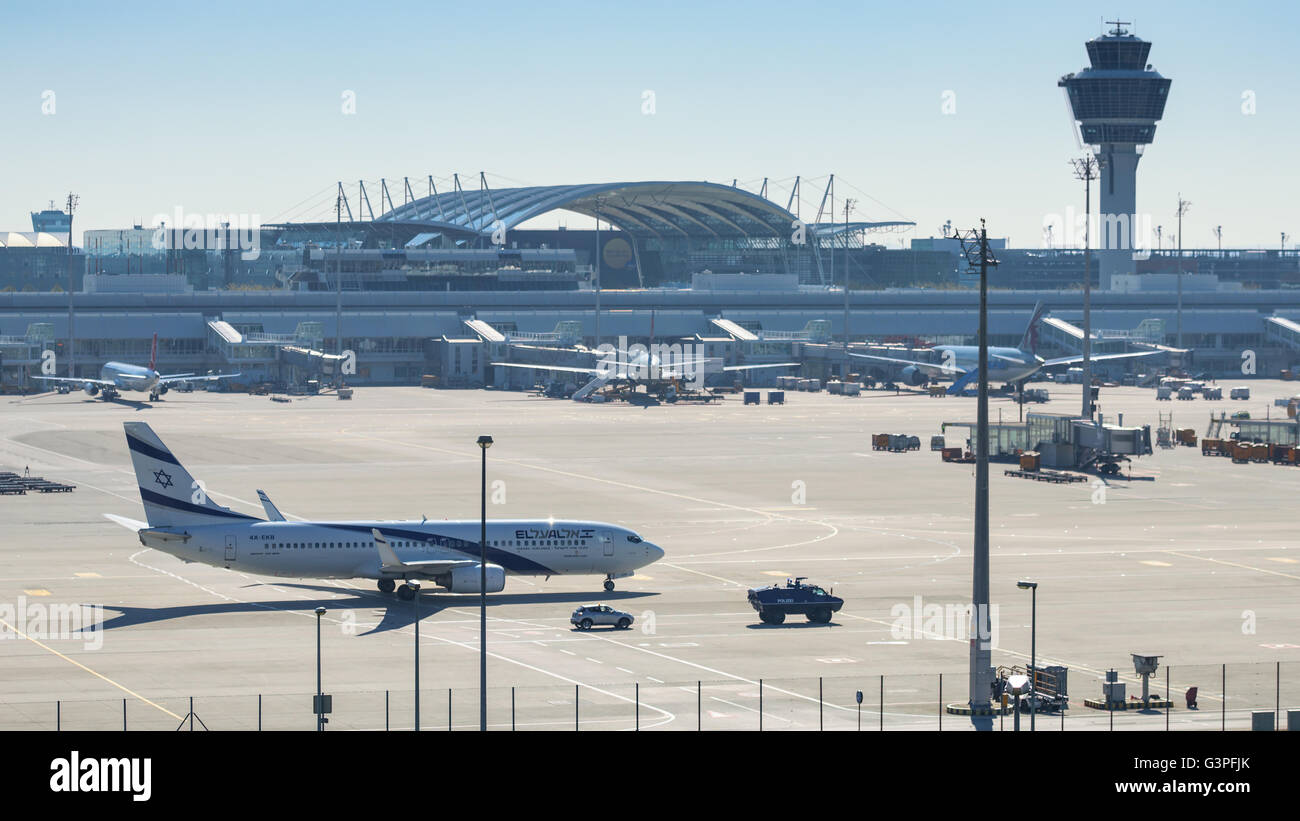 Israeli passenger plane El Al Airlines accompanied by anti terrorism police armored vehicle taxiing to international terminal Stock Photo