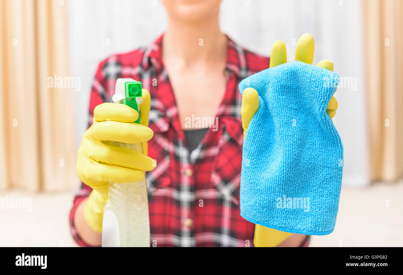 Woman wash that something spray and cloth. Focus on the spray. Stock Photo