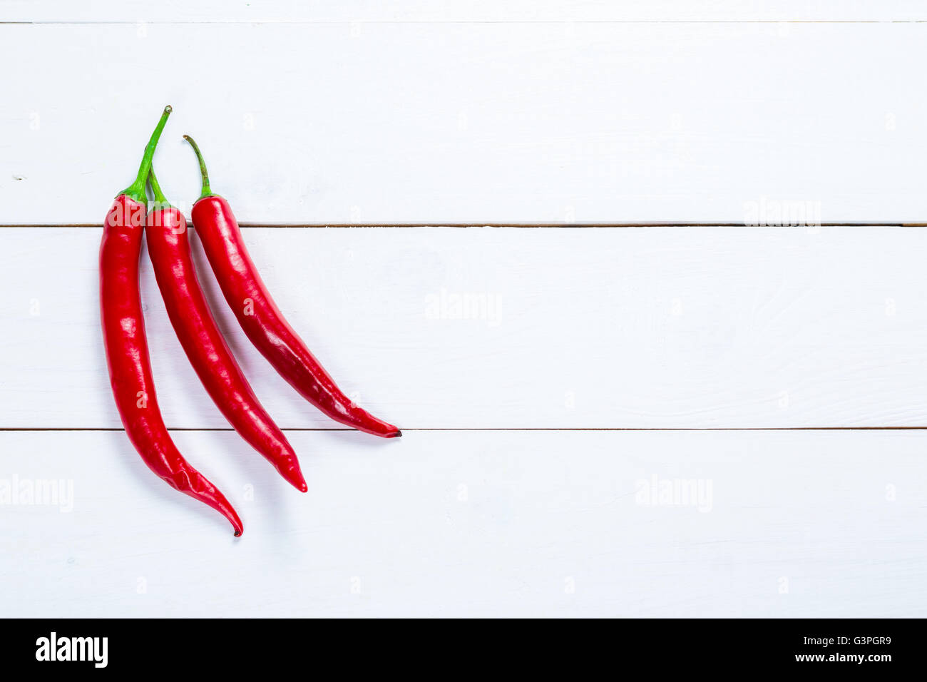 Beautiful background Group of three chili peppers  on the white boards with free space for you text Stock Photo