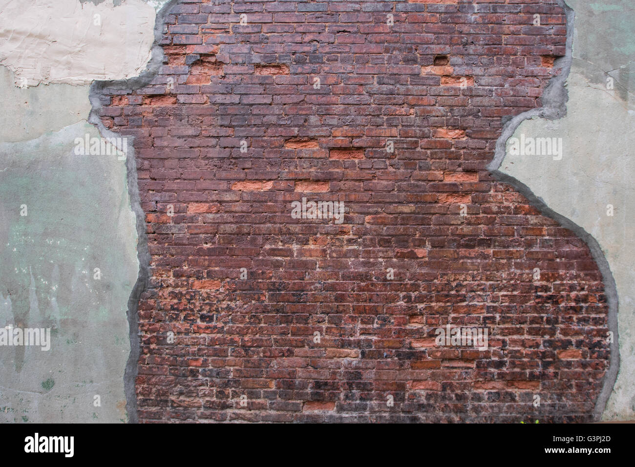 Antique Brick Wall with Worn Grout Skim on Either Side Stock Photo