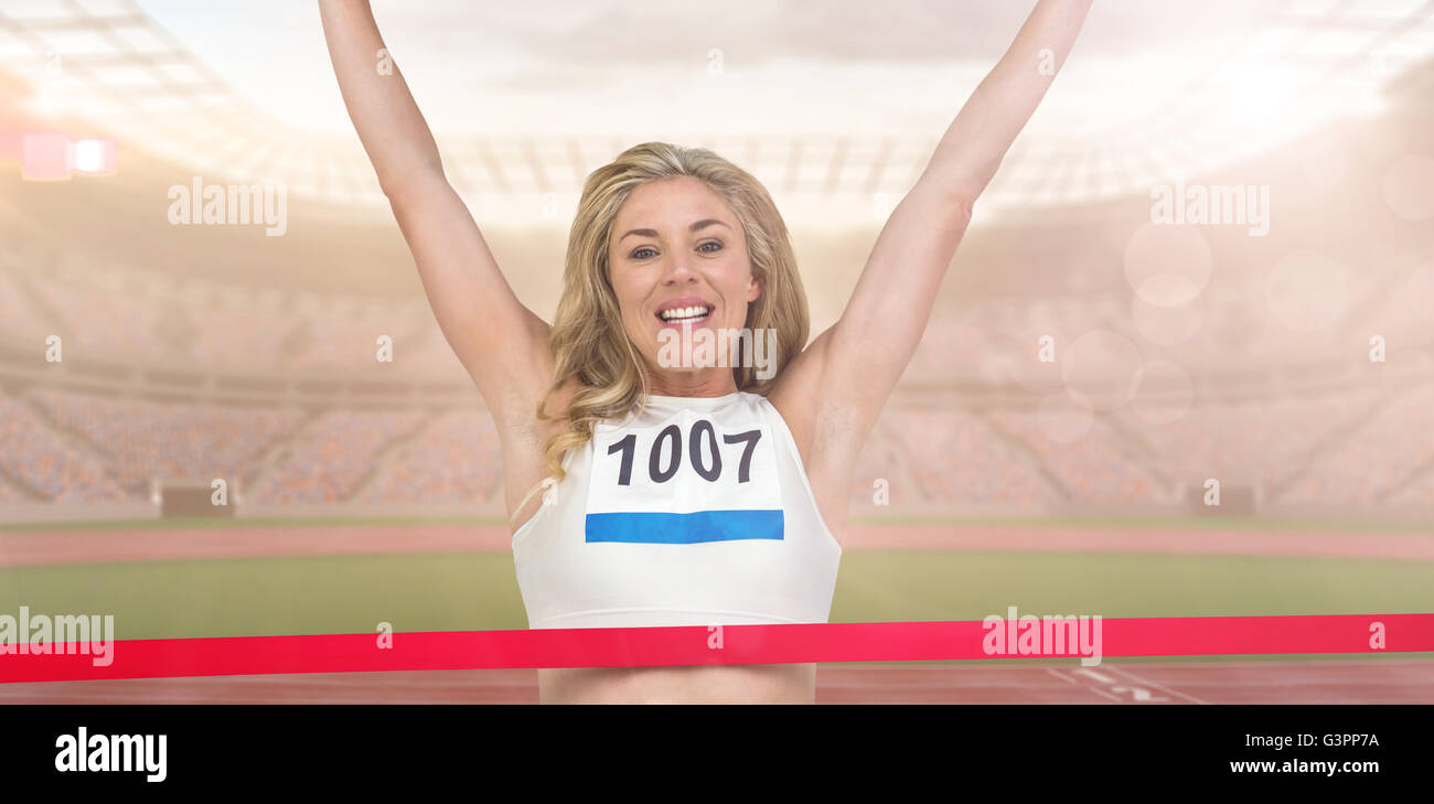 Composite image of portrait of cheerful winner athlete crossing finish line Stock Photo
