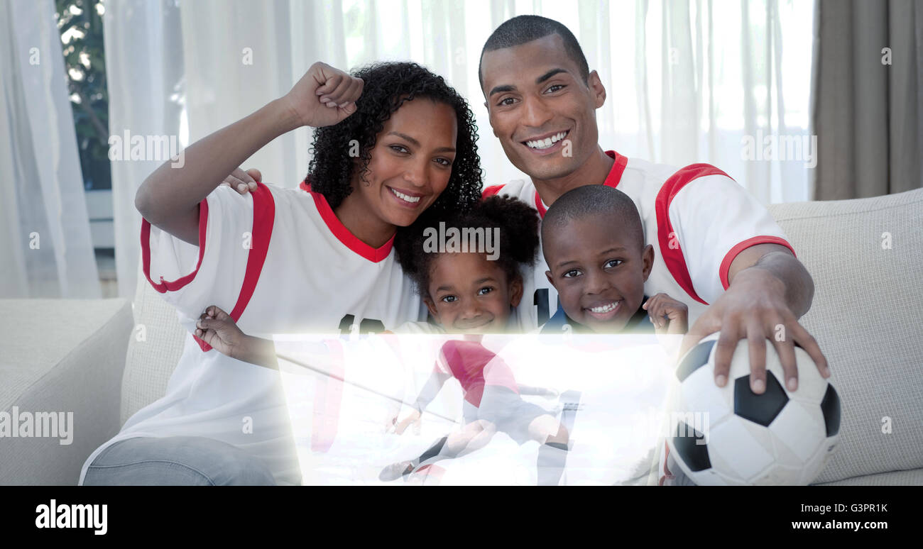 Composite image of family celebrating a football goal Stock Photo