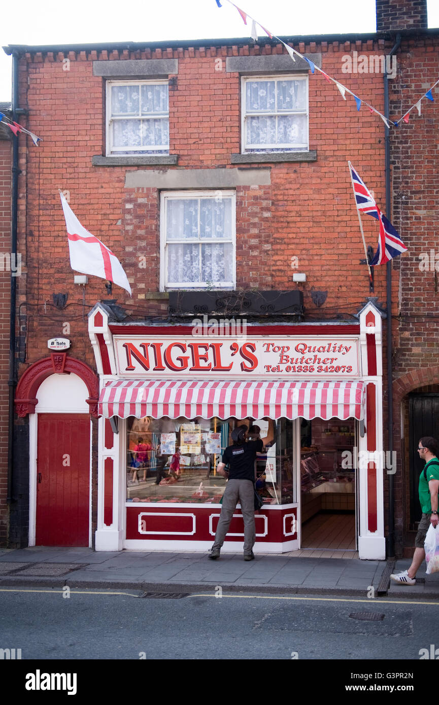 Nigel's butcher in Ashbourne, Derbyshire is covered in flags which looks as if it belongs to Nigel Farage from Vote Leave Stock Photo