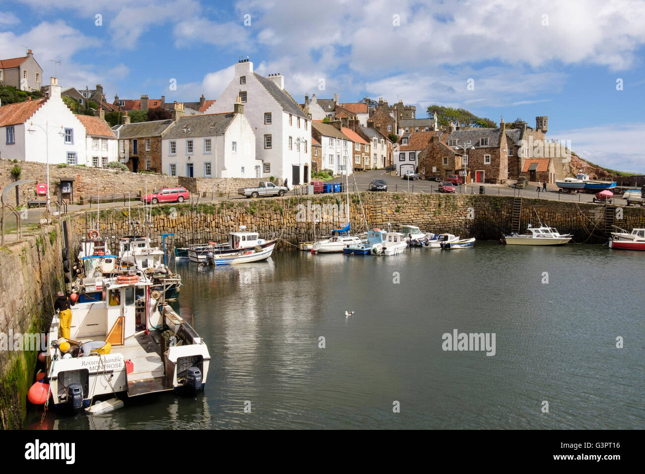 Fishing boats moored in historic village working harbour on Firth of Forth coast. Shoregate Crail East Neuk Fife Scotland UK Stock Photo