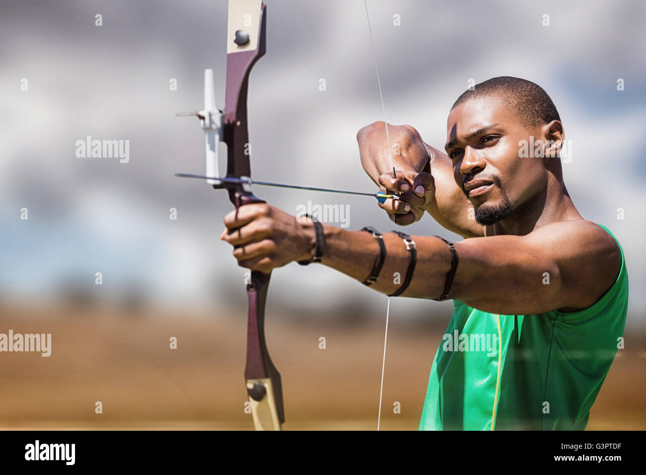 Composite image of close up view of man practicing archery Stock Photo