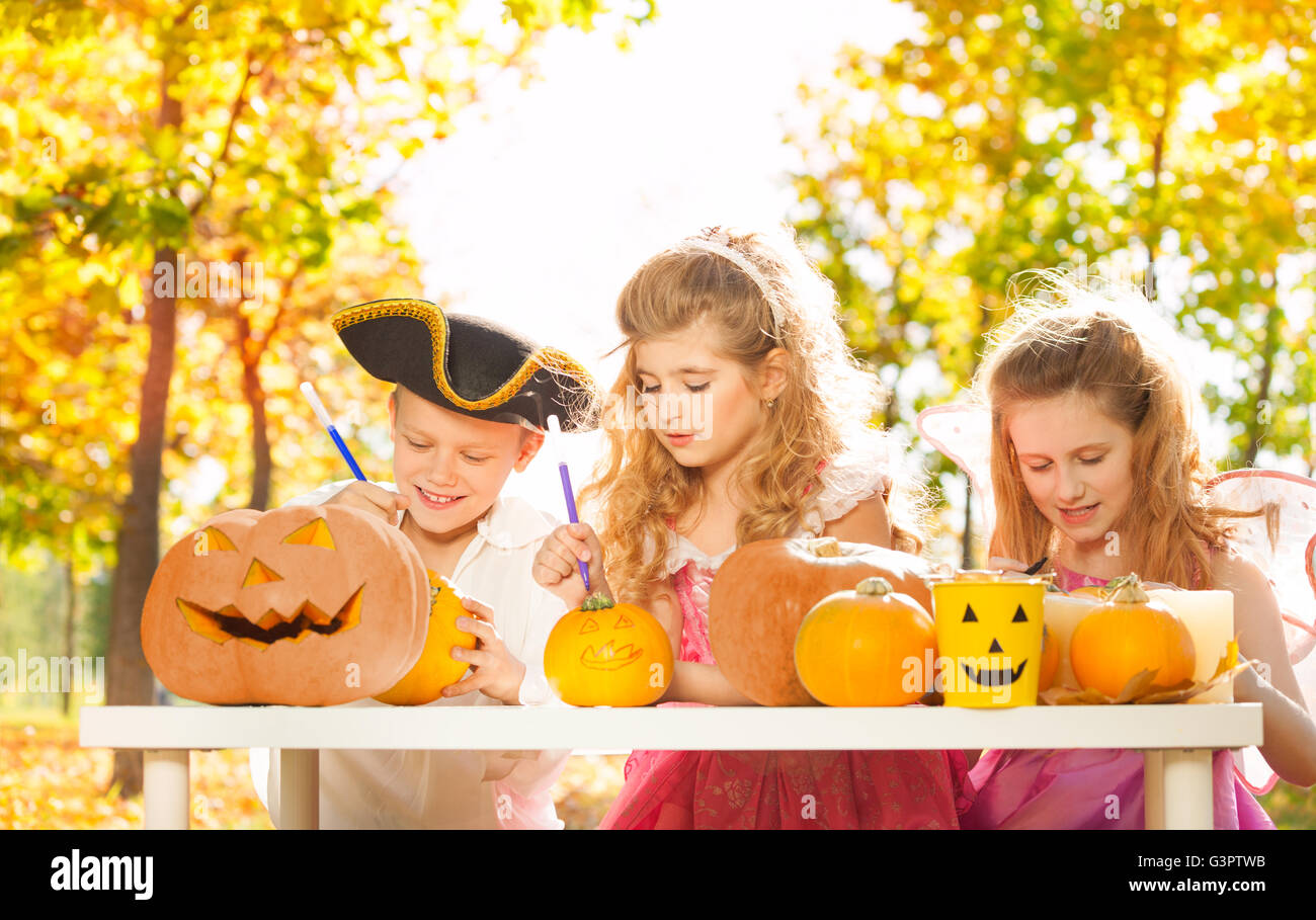Three children during Halloween crafting pumpkins Stock Photo - Alamy