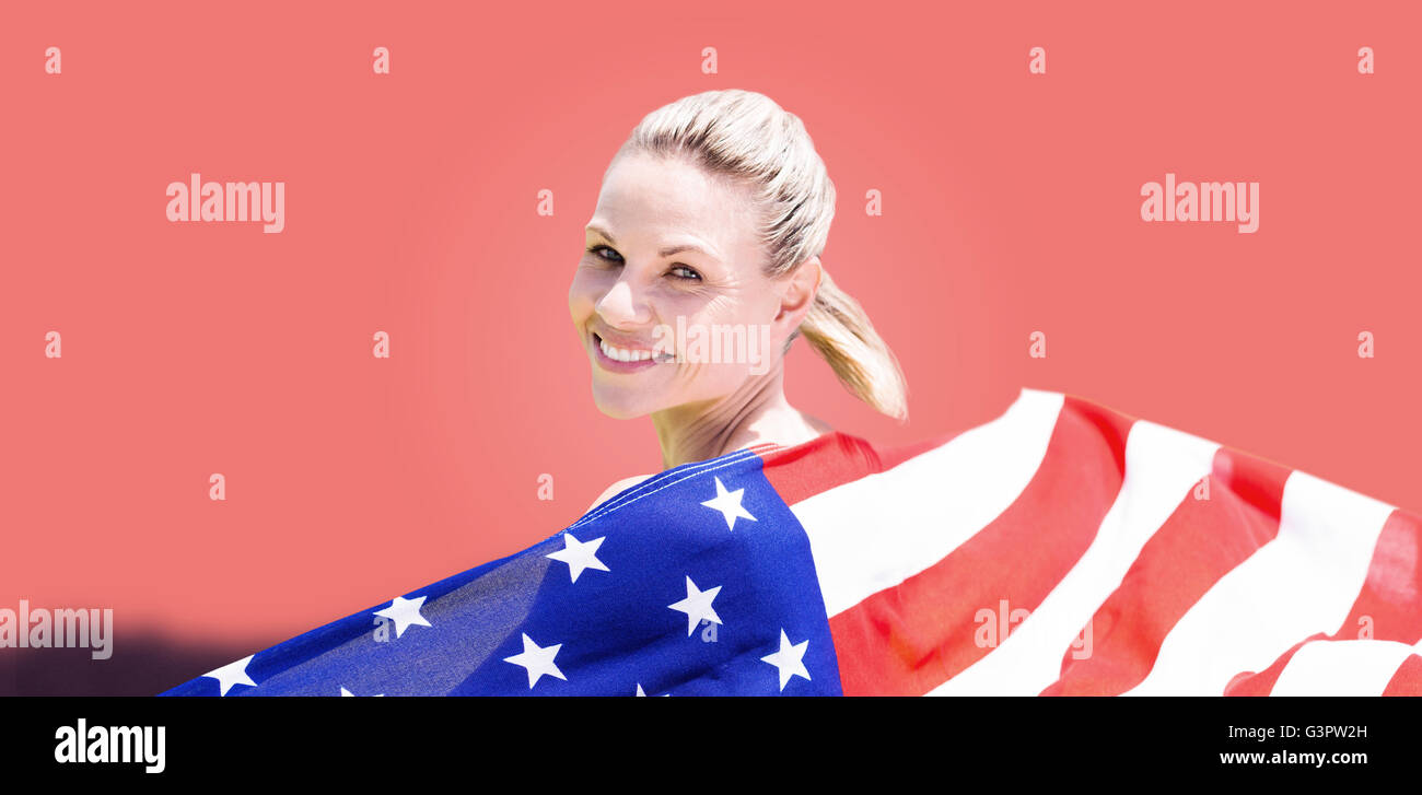 Composite image of sporty girl holding an american flag Stock Photo - Alamy