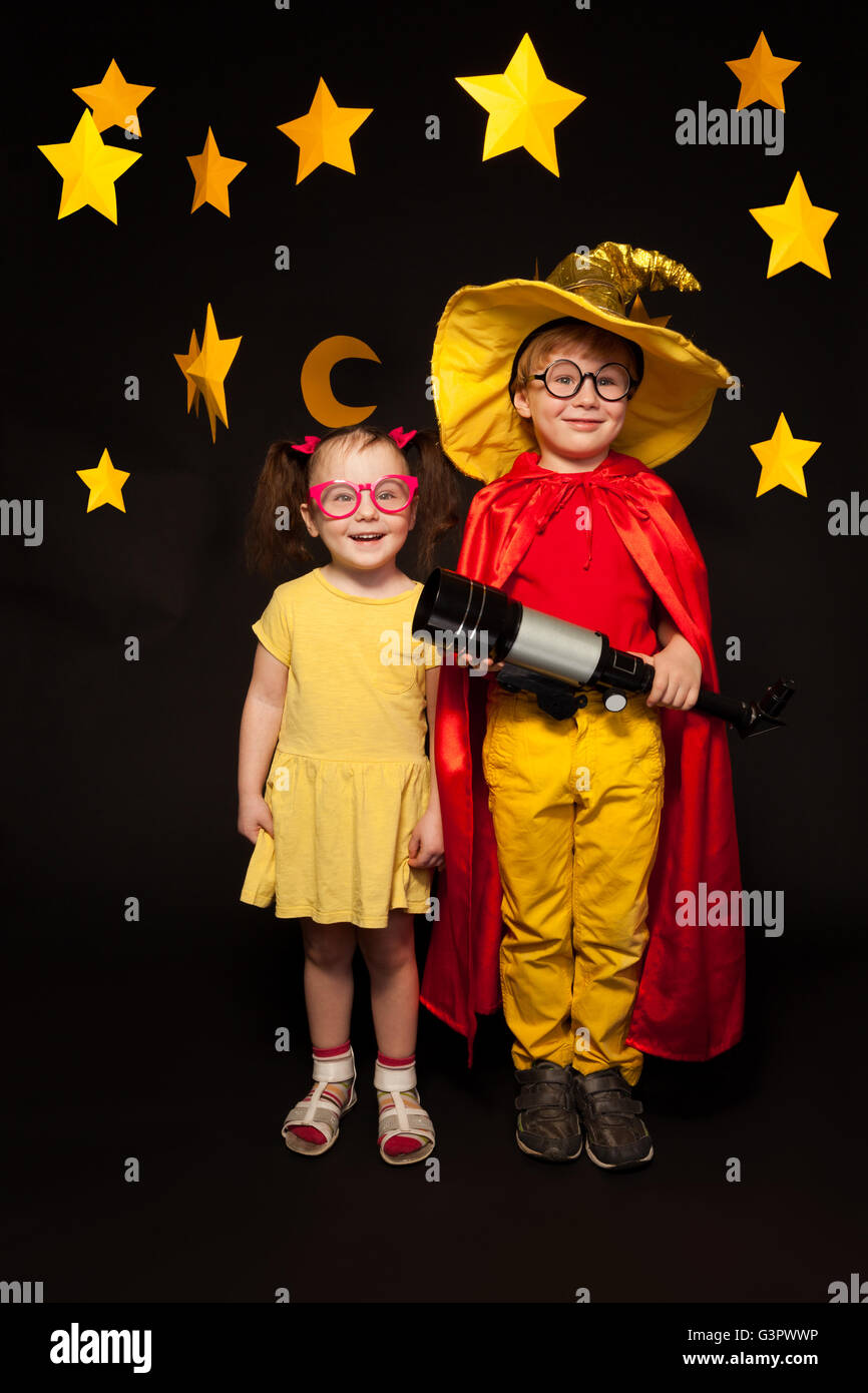 Kids in sky watchers costumes with a telescope Stock Photo Alamy