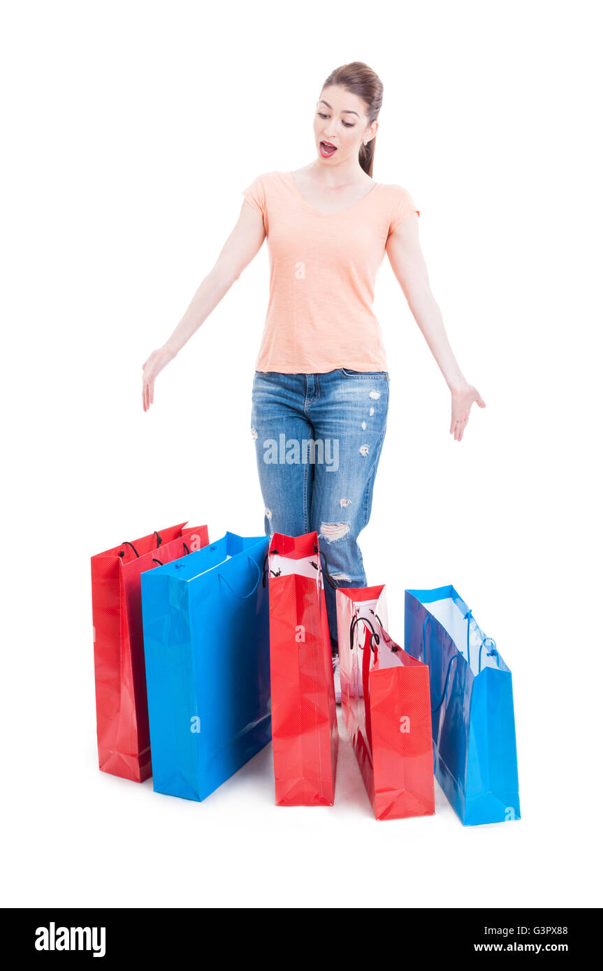 Female shopper standing and feeling enthusiastic with many shopping bags isolated on white banckground Stock Photo