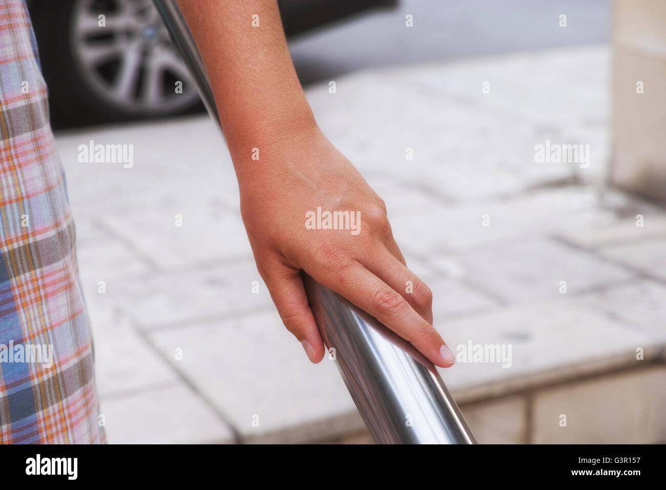 Woman hand using handrail. Urban scene Stock Photo - Alamy