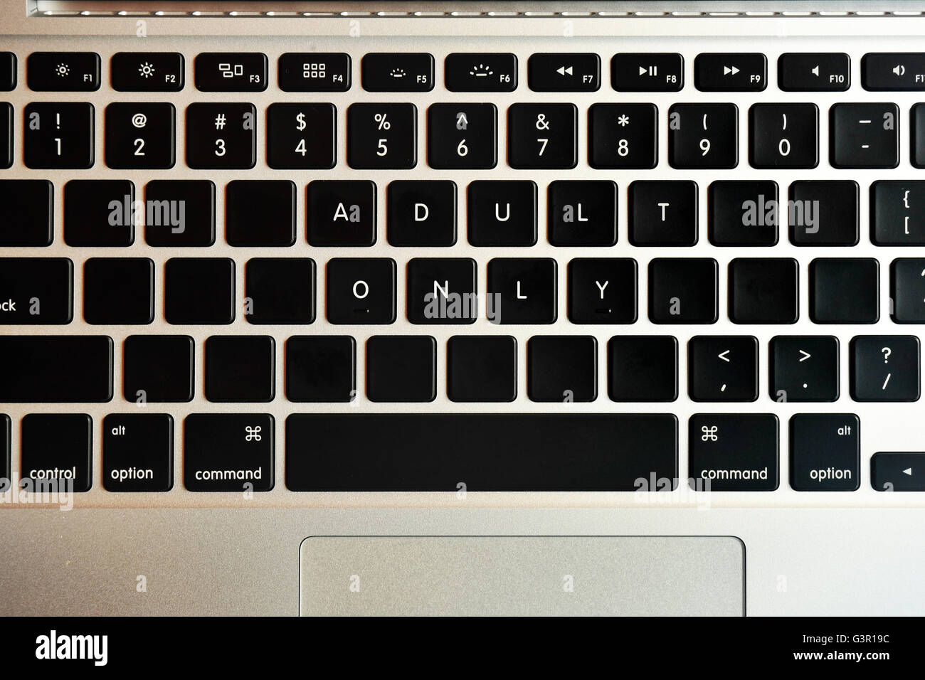 Adult Only written on the keyboard of a MacBook Pro. Stock Photo