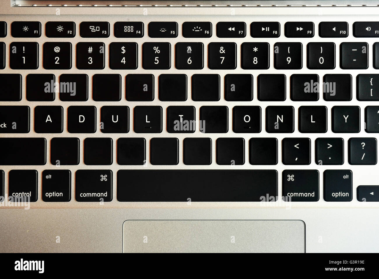 Adult Only written on the keyboard of a MacBook Pro. Stock Photo