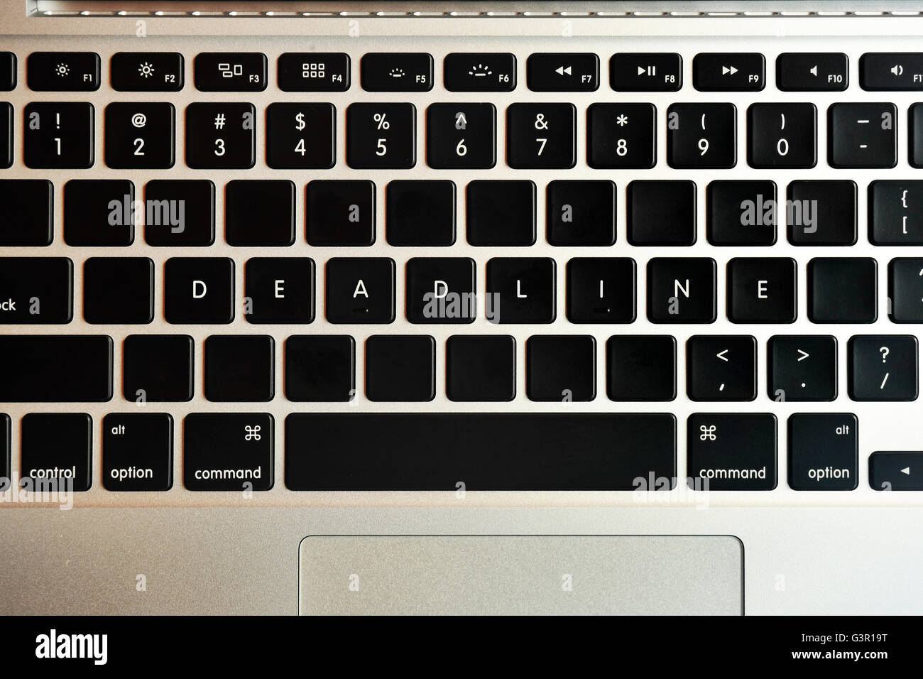 Deadline written on the keyboard of a MacBook Pro. Stock Photo