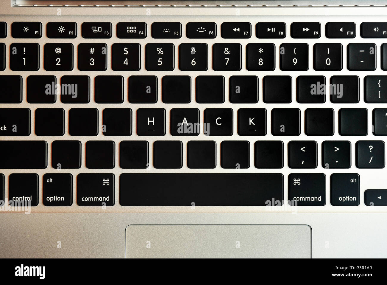 Hack written on the keyboard of a MacBook Pro. Stock Photo