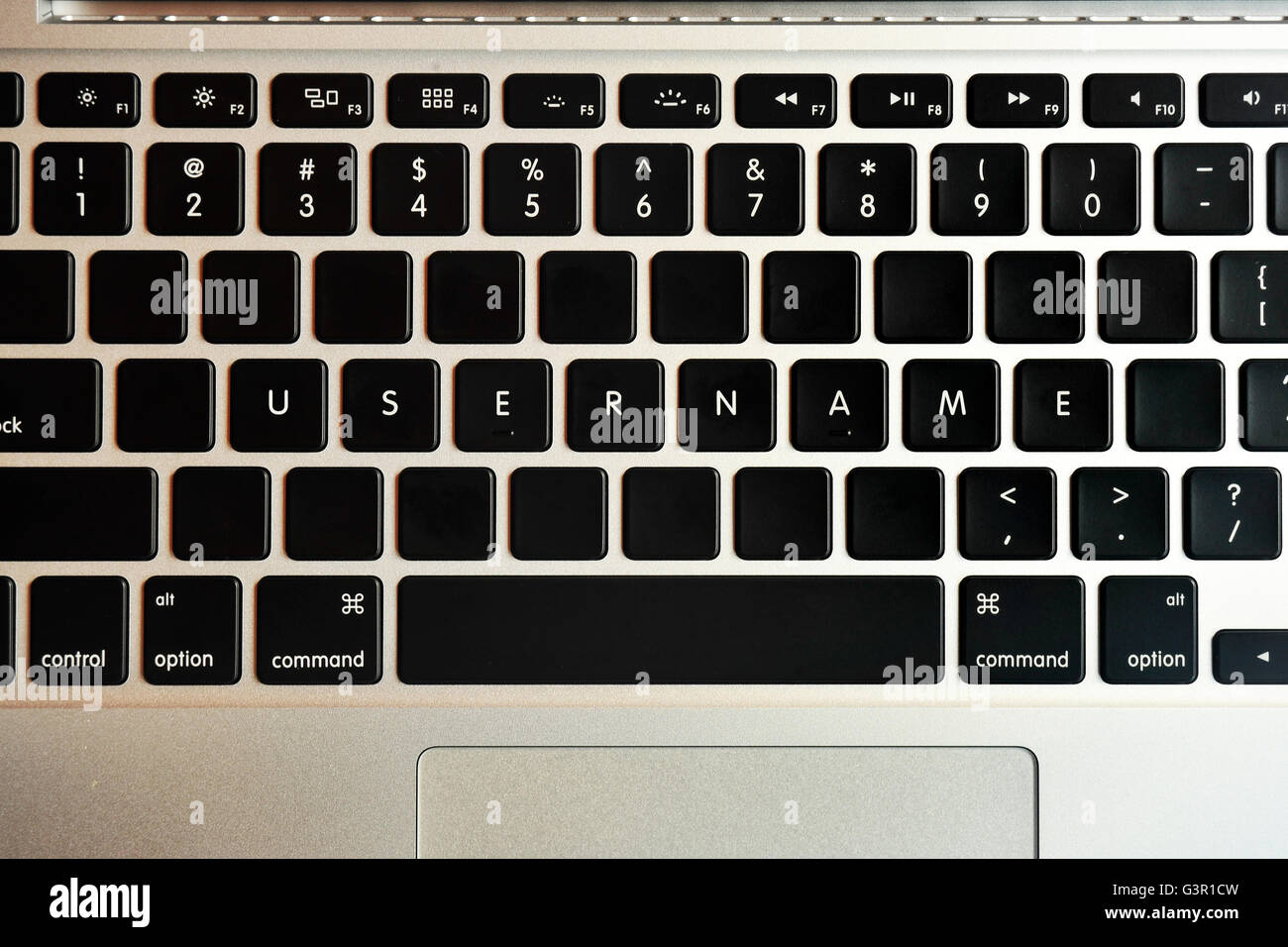 Username written on the keyboard of a MacBook Pro. Stock Photo