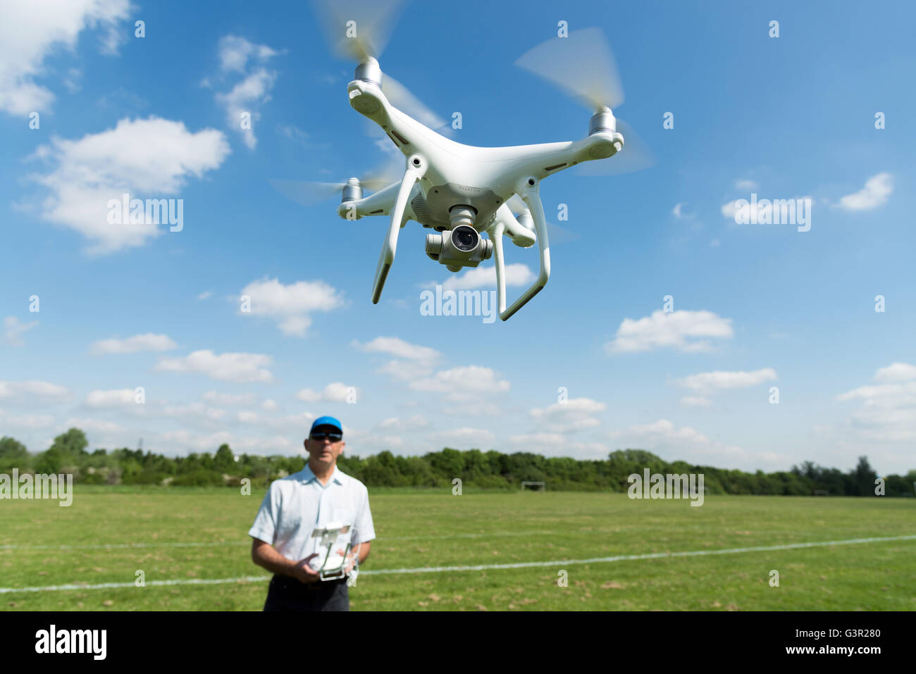Man flying DJI Phantom 4 quadcopter drone in park, England, UK Stock Photo  - Alamy
